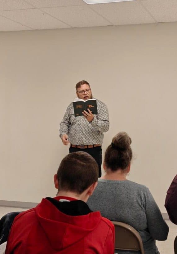A brother leading singing in the Cassville fellowship hall